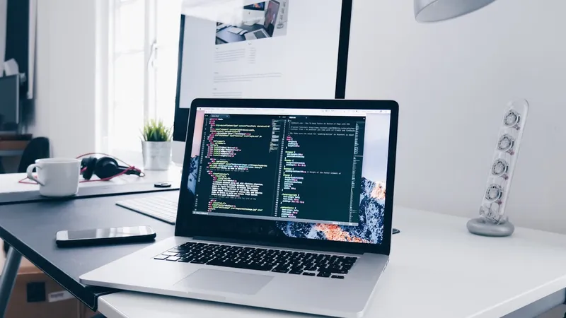Developer workspace with laptop code editor